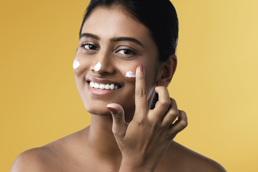 woman applying moisturizer