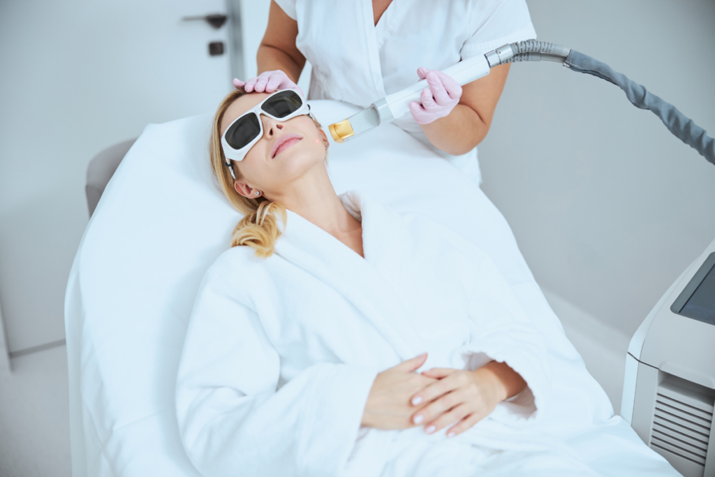 Woman receiving laser treatment on face