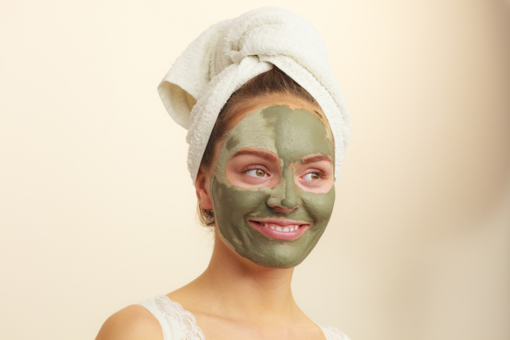 Woman with a clay mask drying on her face