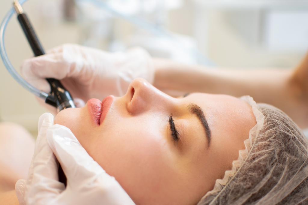 Woman with glowing skin receiving HydraFacial