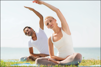 Couple experiencing the benefits of exercise and skin health outside while doing yoga