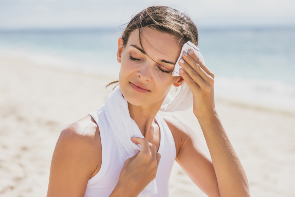 Woman outside wiping sweat off face