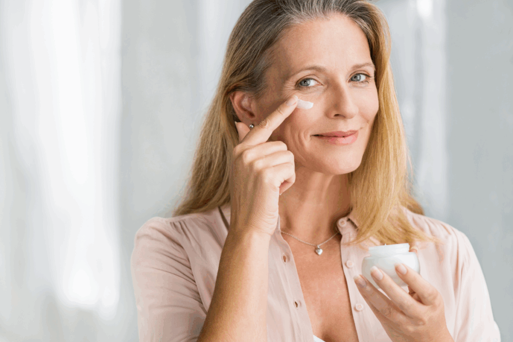 Mature woman with great skin applying moisturizer