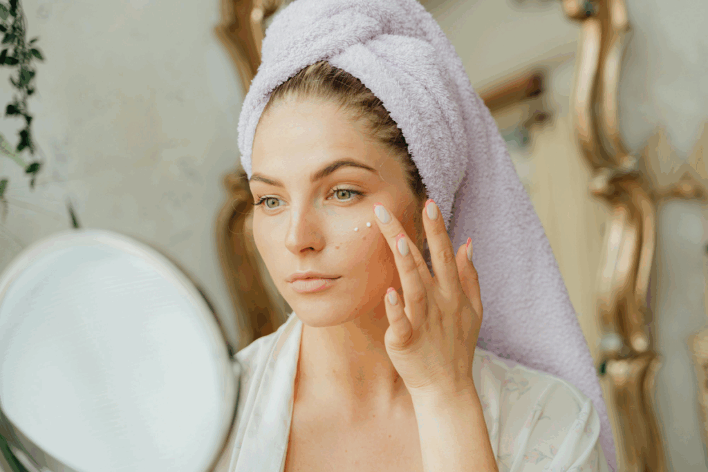 Woman applying light moisturizer as part of her sweat-proof skin care