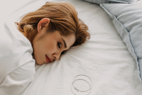 Woman making one of the most common skincare mistakes by sleeping with makeup on