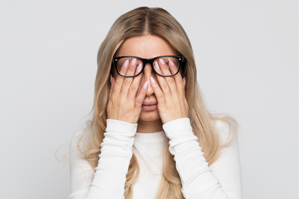 Stressed, tired woman, showing what causes collagen loss