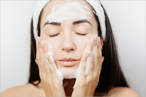 Woman gently cleaning her face