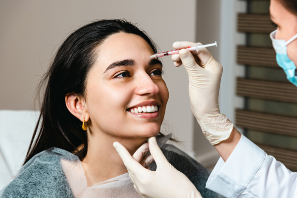 Woman receiving Botox injections at the Glabellar lines