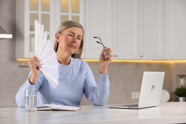 Woman with hormonal acne and hot flashes due to menopause
