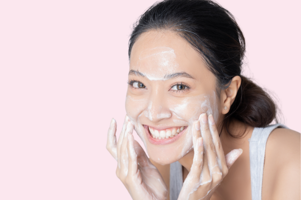 Young woman washing her face