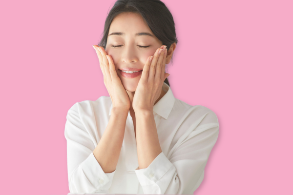 Woman touching her smooth, bright skin, possibly due to Sublative Skin Resurfacing