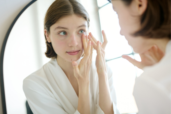 Young woman massaging eye bags