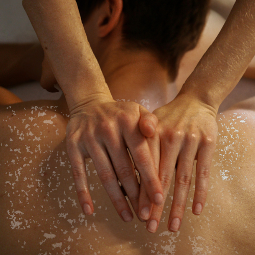 Man receiving backcial (back facial including scrub)