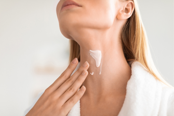 Woman massaging moisturizer into neck Sourced from: https://www.canva.com/design/DAHO0pkVmeY/7y0zgnieV6uh_bLbW7d5kQ/edit?ui=e30#